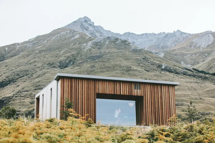 Modern cabin below a mountain