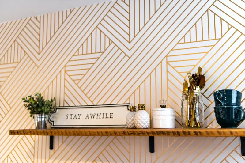 Styled shelf with a Stay Awhile sign